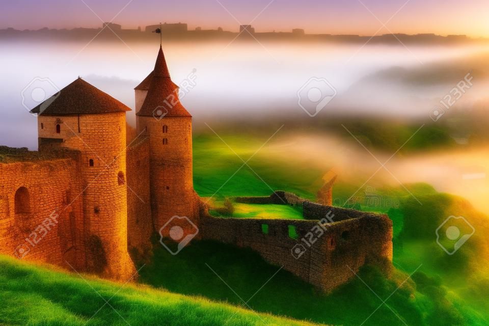 paisaje con antigua fortaleza en la niebla al amanecer