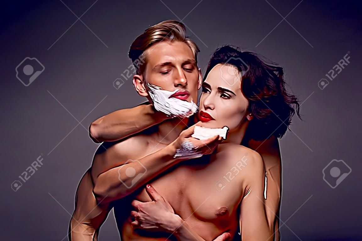 Woman shaving a man