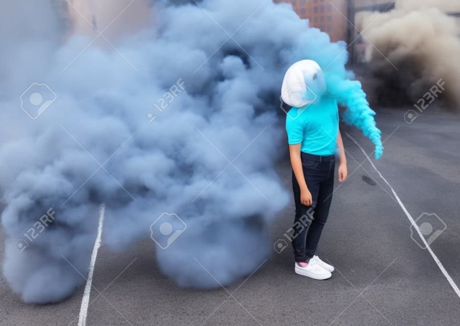 Stylish teenager standing near smoke bomb in city