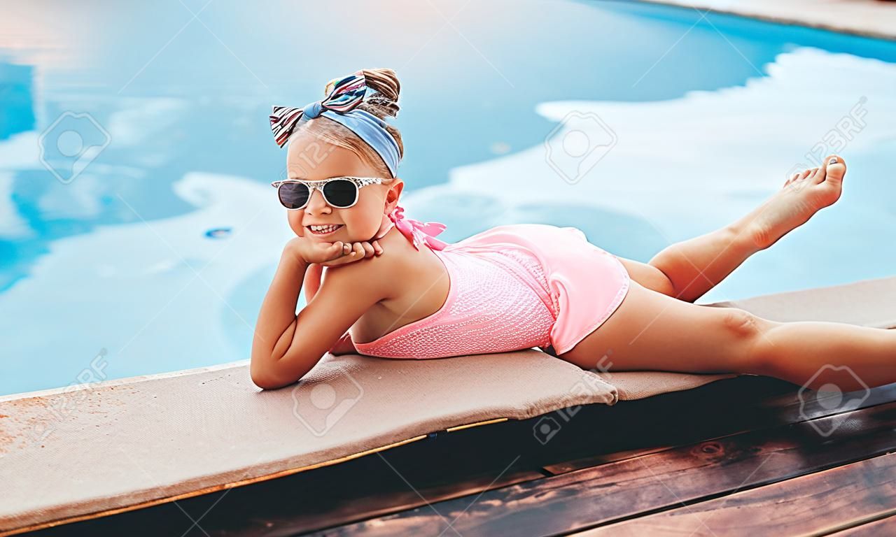 Barefoot girl lounging near pool