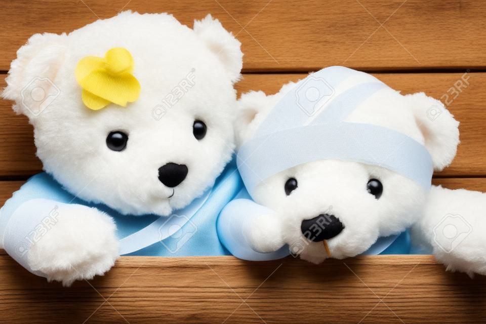 Teddy bears with bandages and broken hand on wood background,copy space.