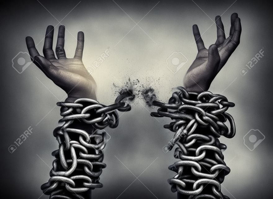 Two hands in chains that are breaking apart.