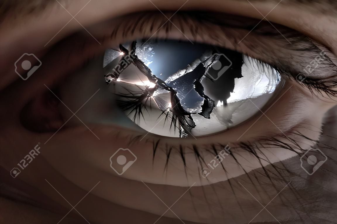 Surreal image of an eye broken with glass