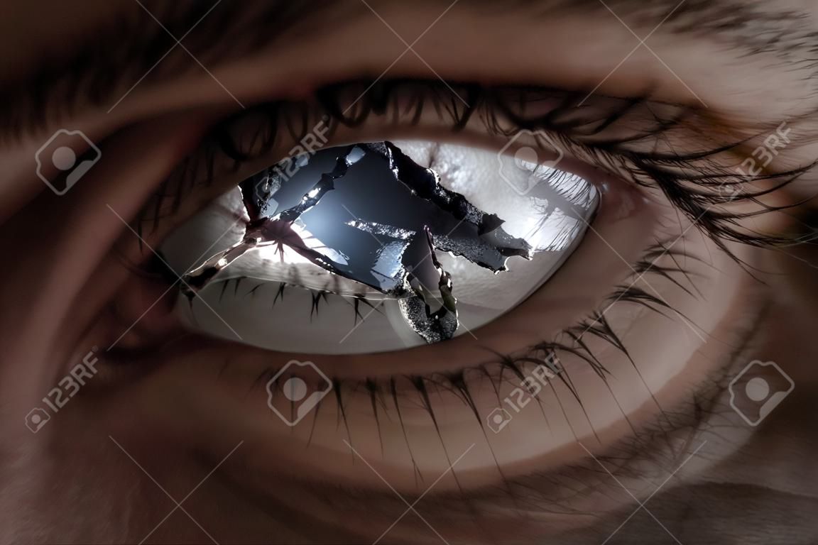 Surreal image of an eye broken with glass