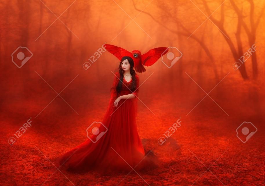 powerful autumn nymph, queen of fire and goddess of hot sun, lady in long red light dress with loose sleeves with dark hair, model in scarlet forest with flying owl, bloody Mary, vampire image
