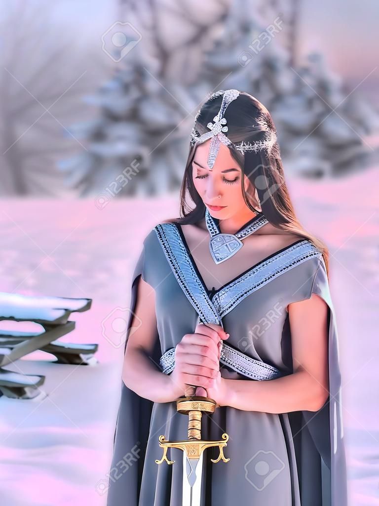 charming sweet dark-haired girl with closed eyes reads prayer to gods of war before terrible fight, elegant princess holds silver sword, meditation with weapon for hardening spirit of warrior