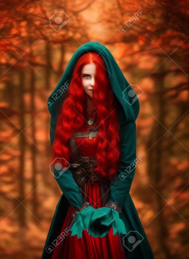 Portrait mystical fantasy red-haired woman witch looking at camera. Girl princess. Blue green medieval Victorian dress. Glamorous lady queen, red long curly hair waving flying in wind. Autumn forest.