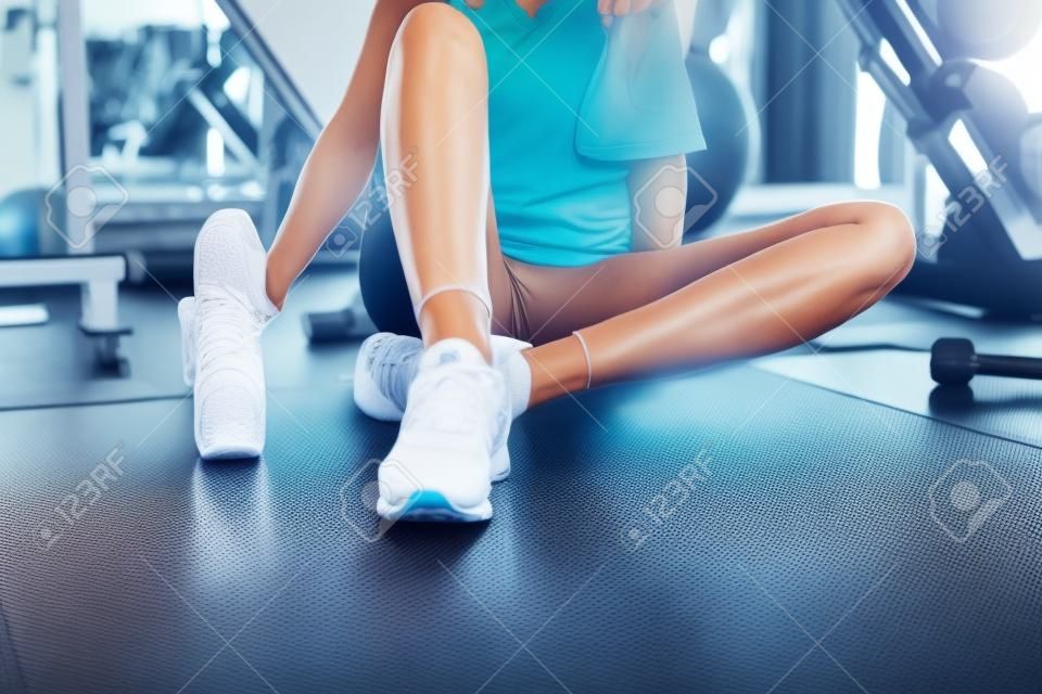 Portrait of Pretty Caucasian Woman is Exercised in Fitness Club, Attractive Woman is Resting After Working Out Jogging on Treadmill Machine in Gym., Sport Club and Healthy Concept.
