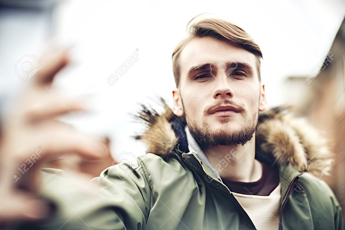 Handsome caucasian young man in casual clothes in urban environment