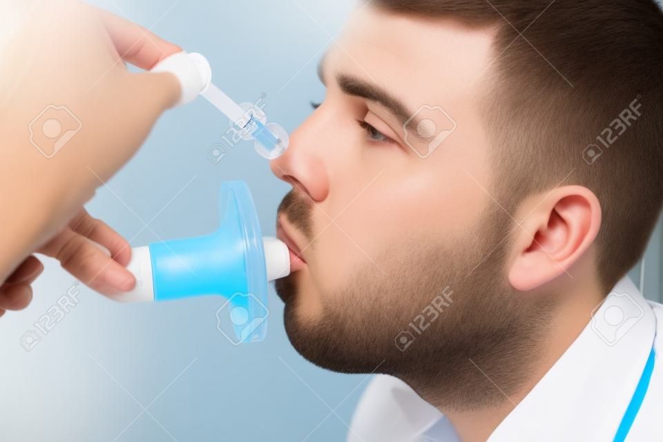 Young man testing breathing function by spirometry