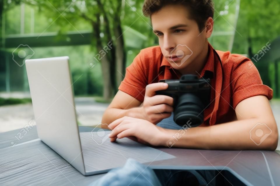 Caucasian young man is sitting outside