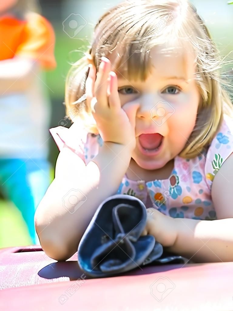 closeup summer portrait of a cute little girl outdoors