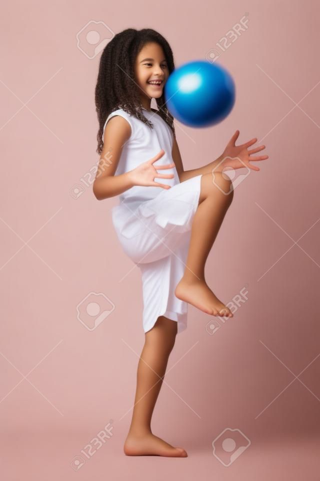 happy teenager with ball on white background