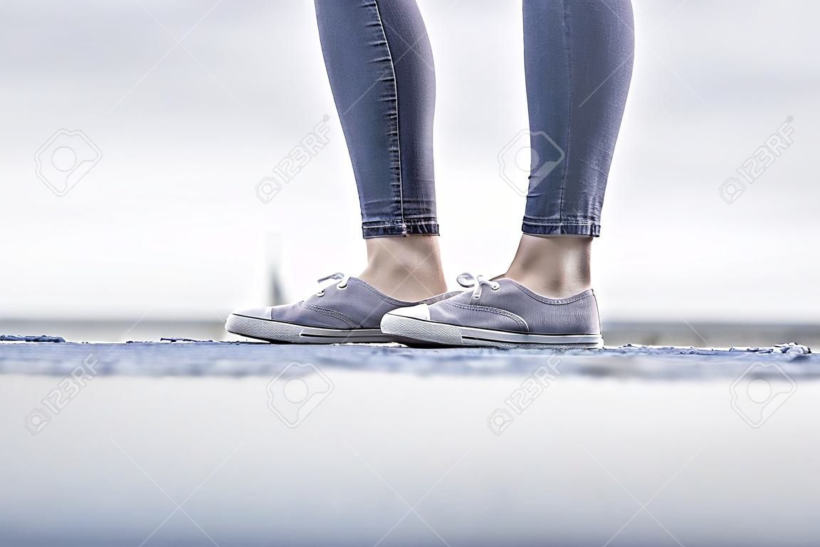 casual dress of the girls -shoes and slim jeans. Focused