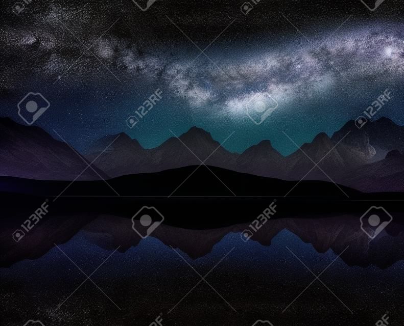 Night sky with stars and the Milky Way over a mountain lake. Collage of two frames. Art processing photos