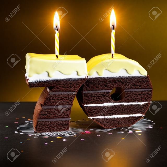 紙屑包圍的巧克力生日蛋糕，點燃蠟燭為70歲生日或週年慶祝活動