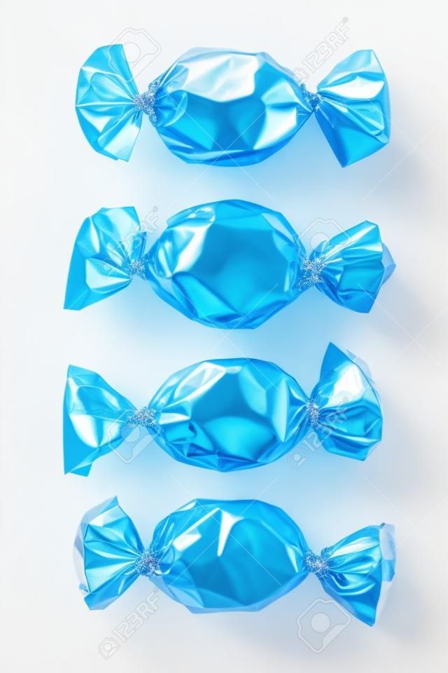 Close-up shot of hard candies in shiny candy wrapped arranged side by side over white.