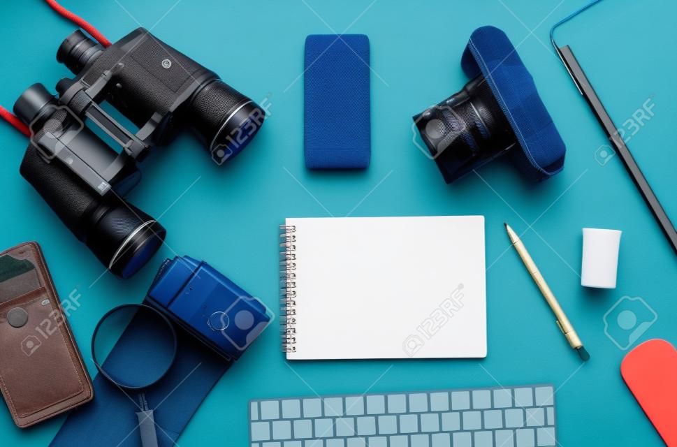 Flat lay of accessories on blue desk background of photographer, Voyage concept.
