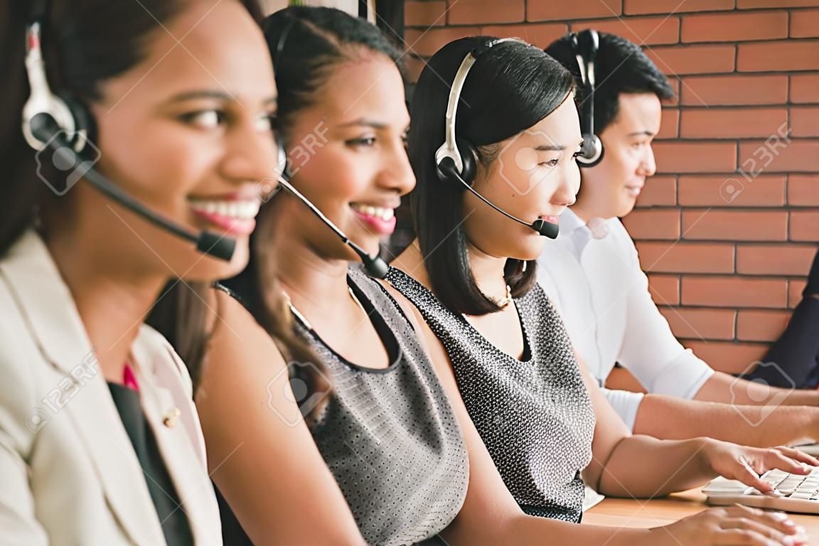 Smiling multiethnic telemarketing customer service agent team working in call center office with healpful attutude