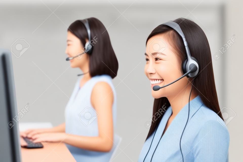 Smiling Asian woman telemarketing customer service agent team, call center job concept