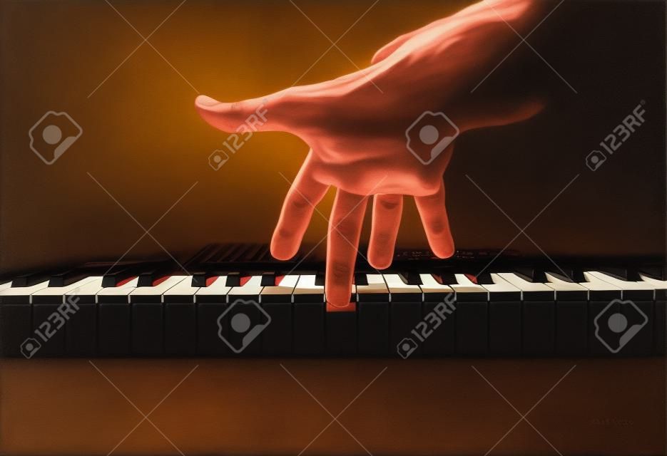 Playing a keyboard, one male hand playing, accentuated contrasts.