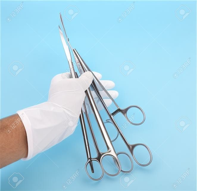 Surgical instrument in hand doctor on white 