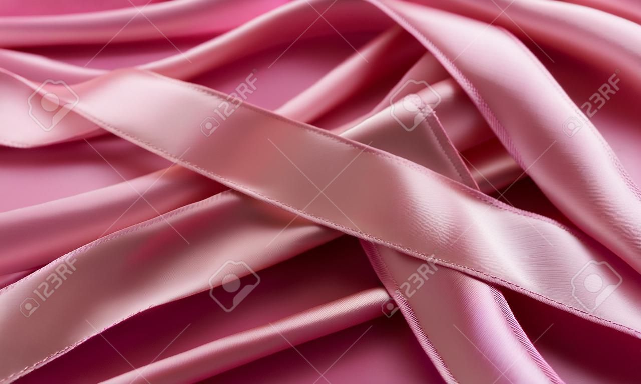close up of pink satin ribbons for background and texture use