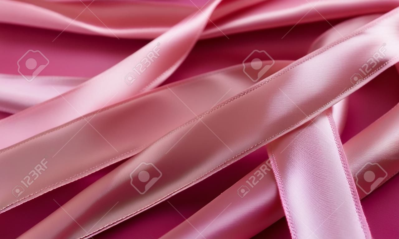 close up of pink satin ribbons for background and texture use