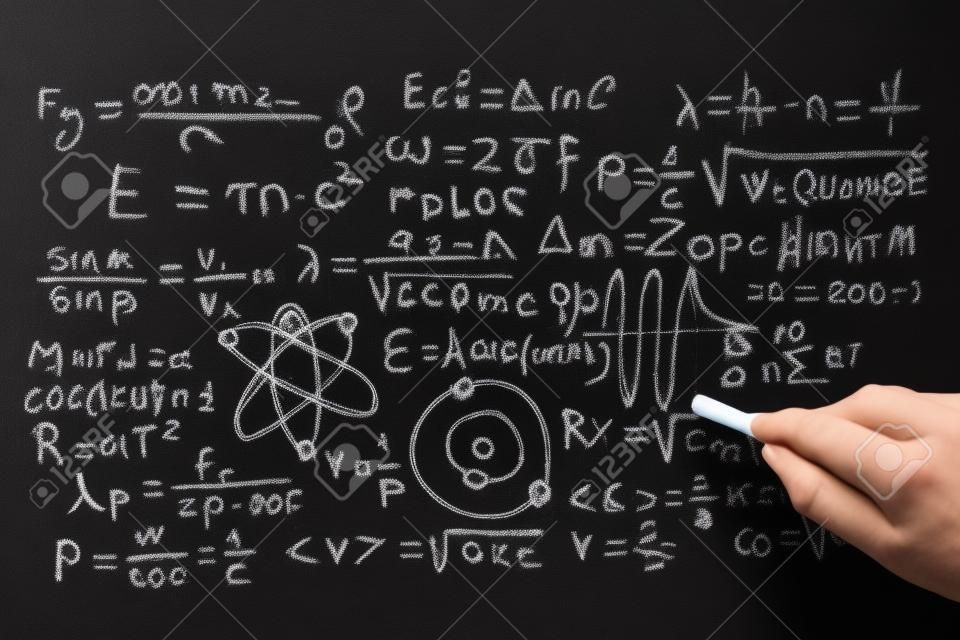 Quantum physics operations written by hand with a chalk on the blackboard
