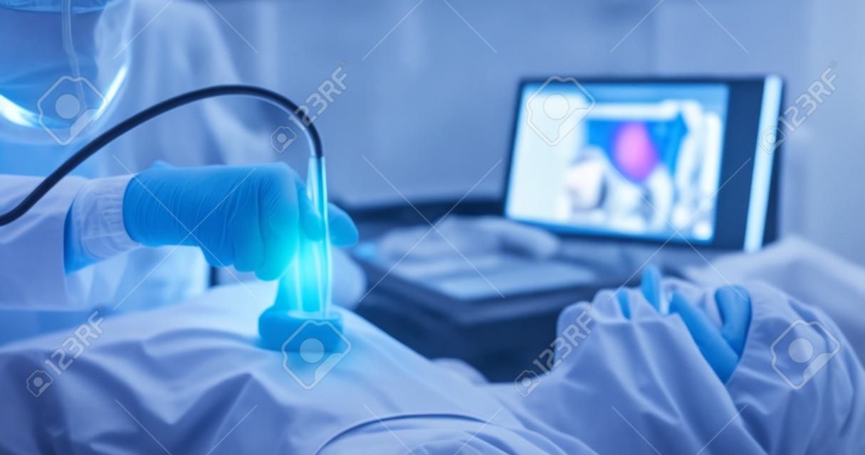 Doctor examining patient chest using ultrasound scanner closeup