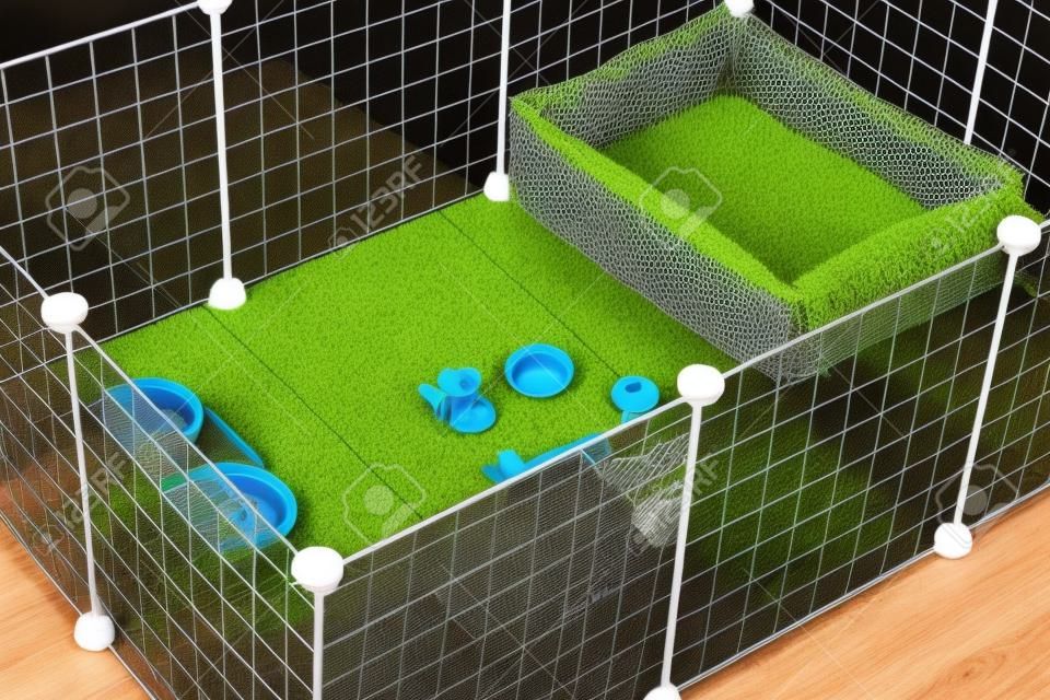 An aviary for a dog with toys and food cups. Comfort for pets.