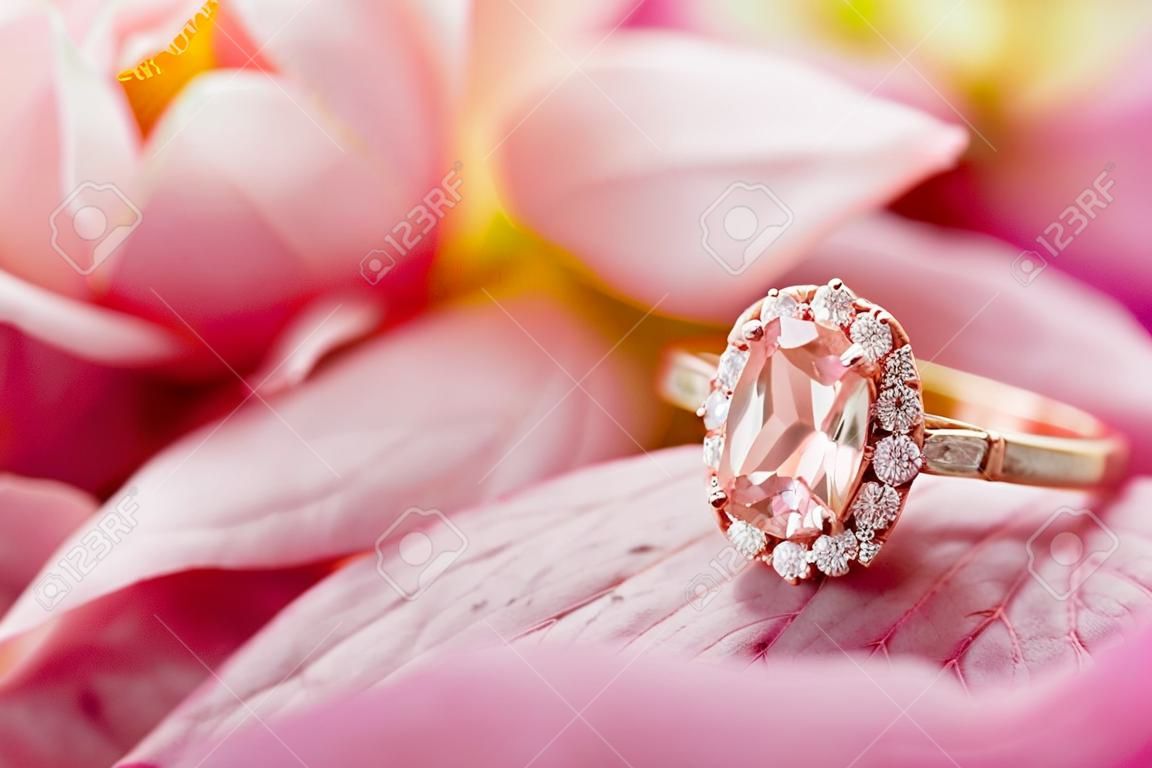 Jewelry pink diamond ring on beautiful rose petal background close up