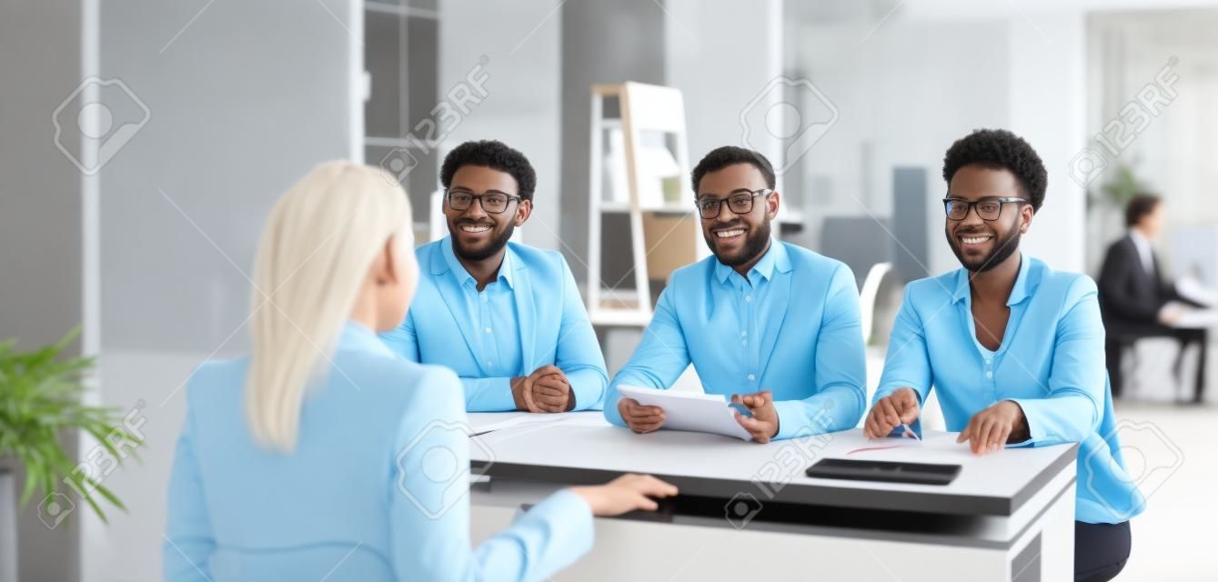 Diverse Team Of HR Managers Talking To A Young Woman. Three People At The  Office Desk Listening To A Job Candidate Answering Question About Work  Experience. Job Interview, Business Recruitment Concept Фотография,