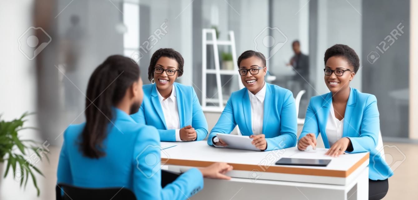 Diverse Team Of HR Managers Talking To A Young Woman. Three People At The  Office Desk Listening To A Job Candidate Answering Question About Work  Experience. Job Interview, Business Recruitment Concept Фотография,