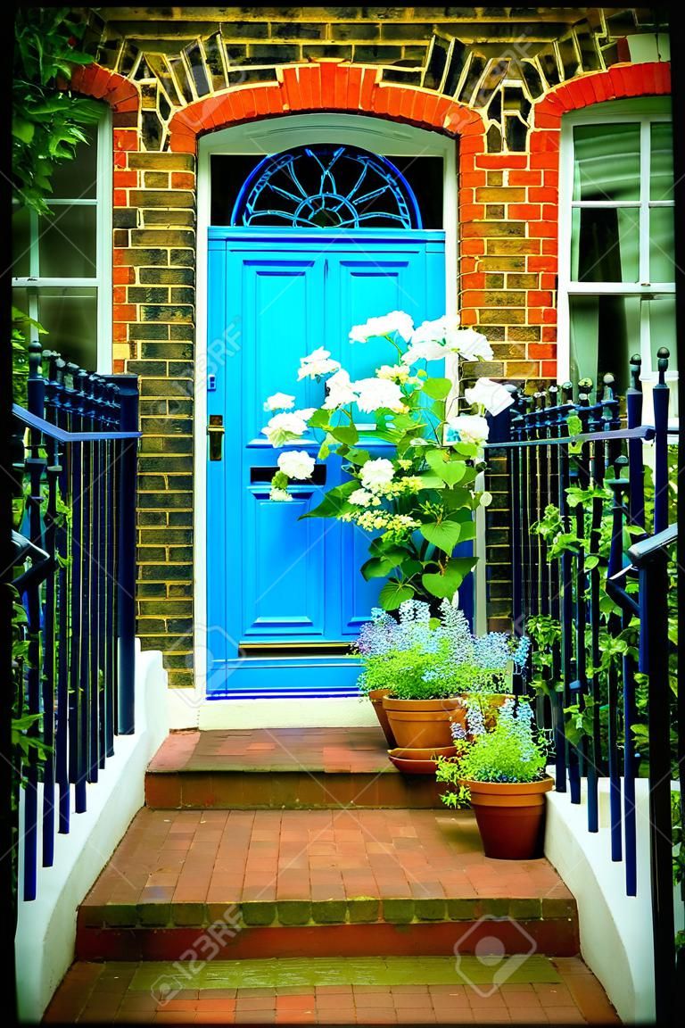 London, entrance to a house with flower beds full of flowers