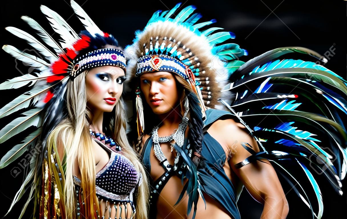beautiful manand woman, striptease dancers wearing  Native American costumes