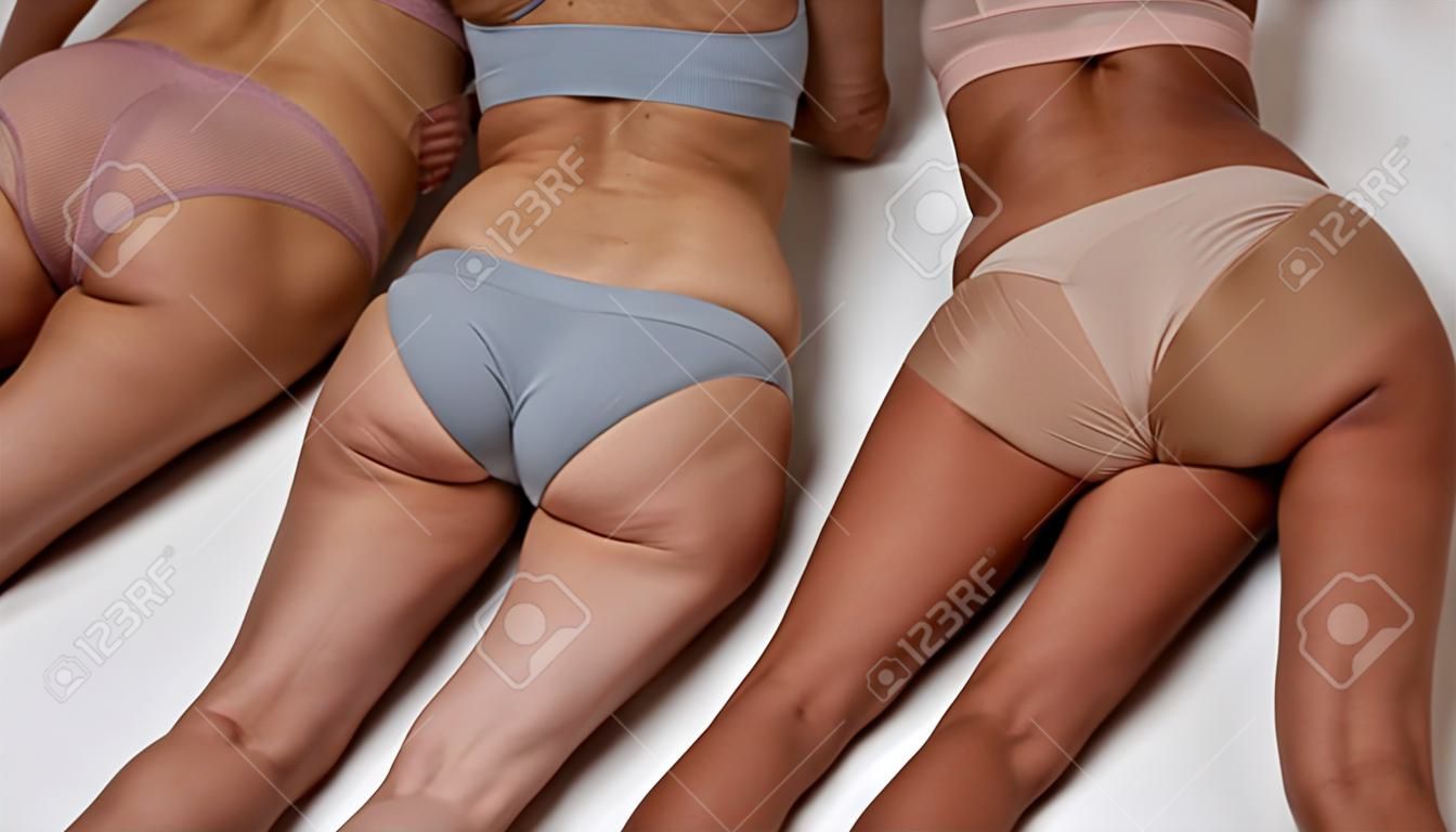 Women lying on their bellies and showing butts to camera