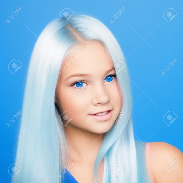 showy blond teen girl on the blue background closeup