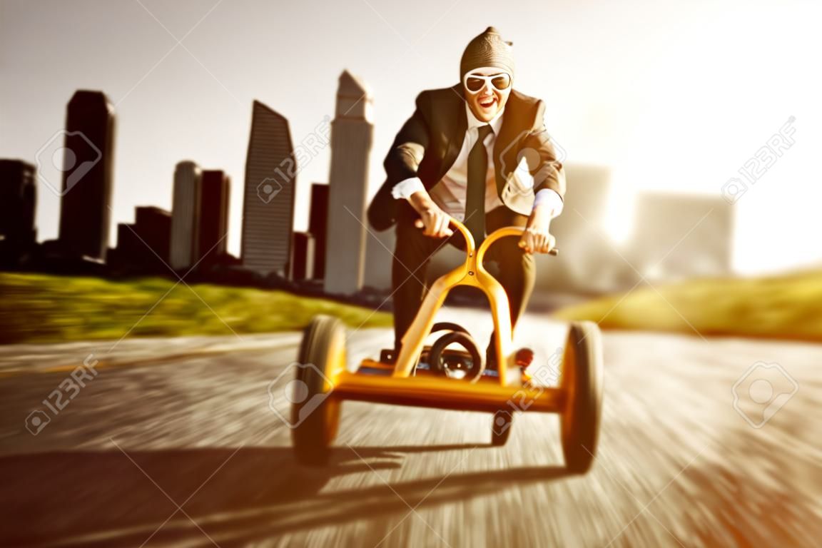 Business man on a pedal car