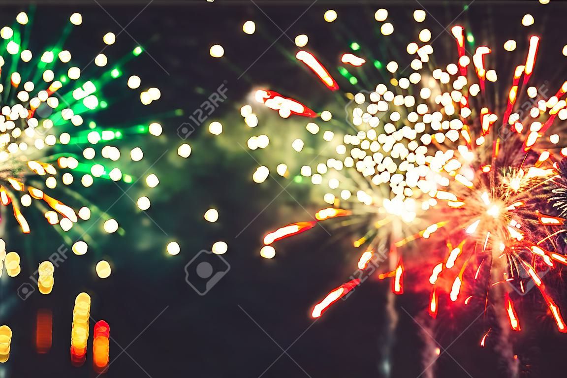 Fireworks at New Year and copy space abstract holiday background. Brightly Colorful Fireworks on twilight background with free space for text. New Year