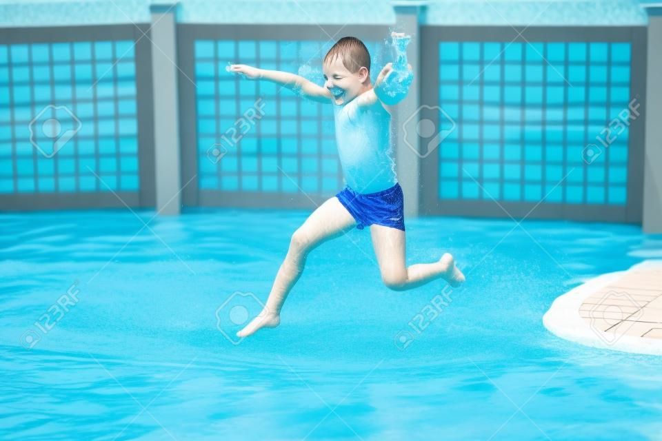 child jumps into the pool with water