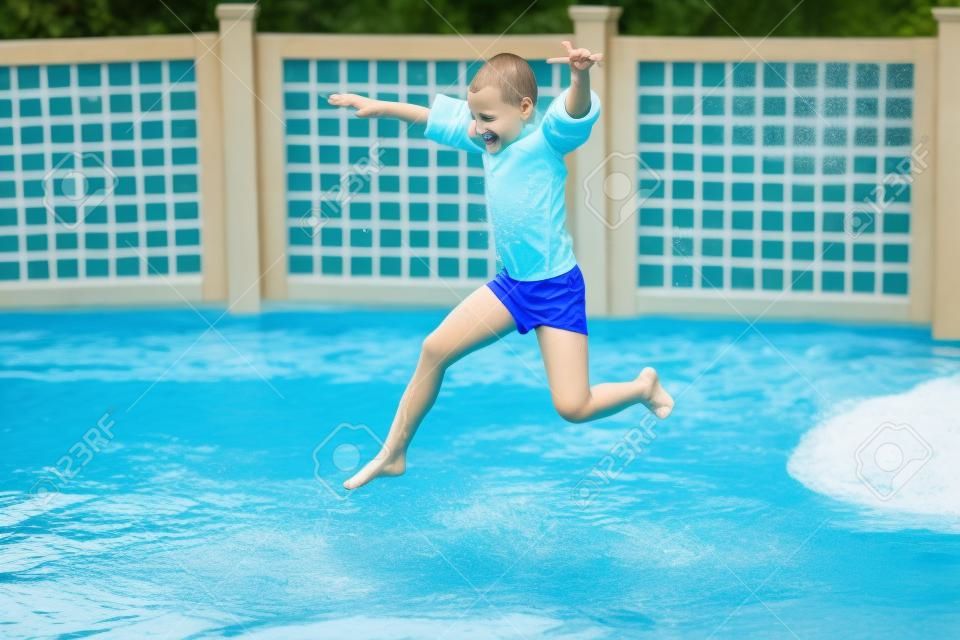 child jumps into the pool with water