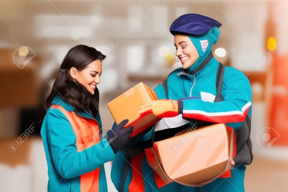 Young Woman Receiving A Package From Courier Delivery Man