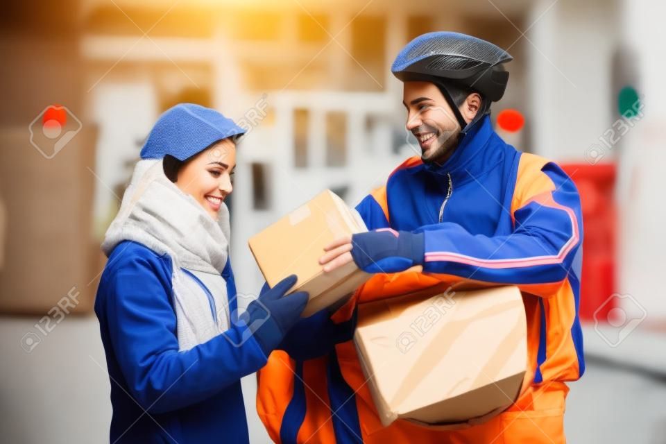 Young Woman Receiving A Package From Courier Delivery Man