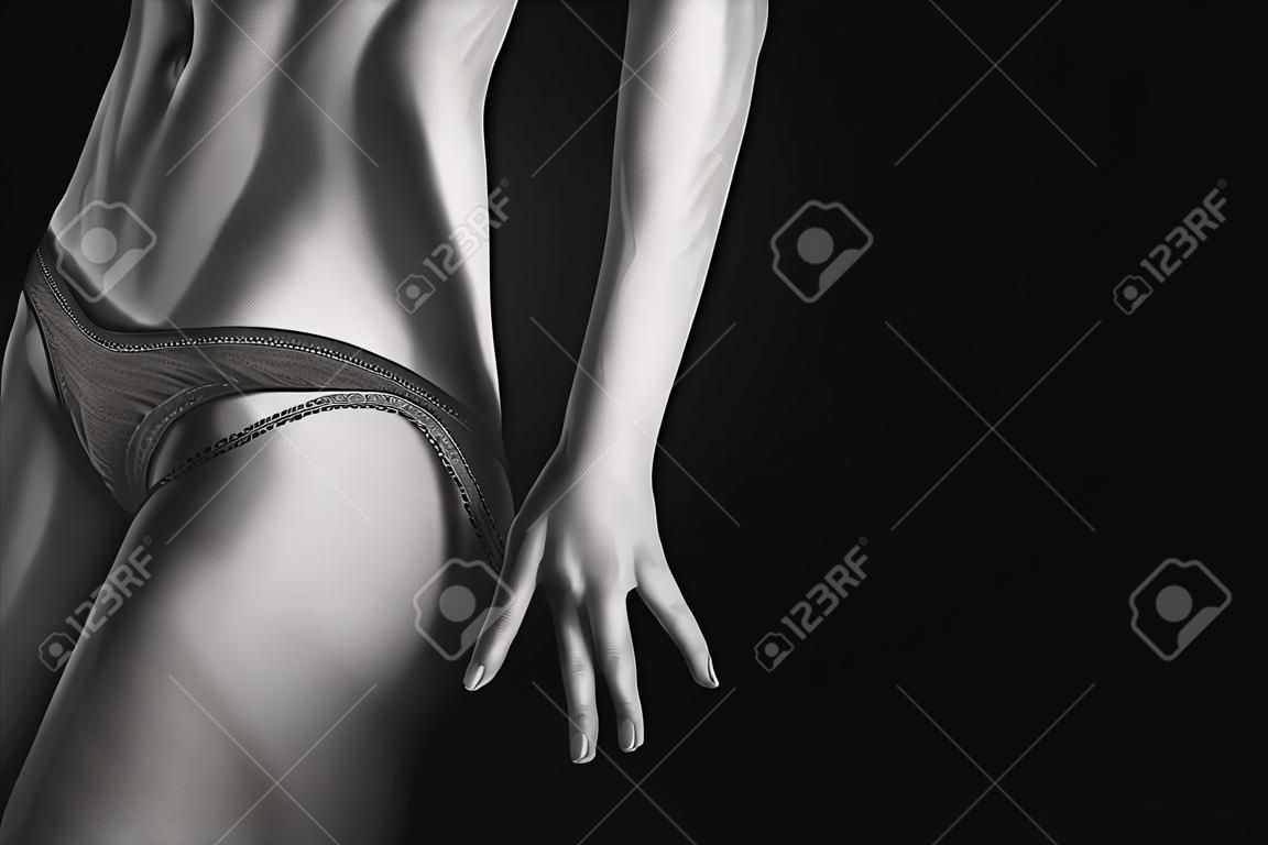 undressing panties from tan slim female body on black background with copyspace, monochrome