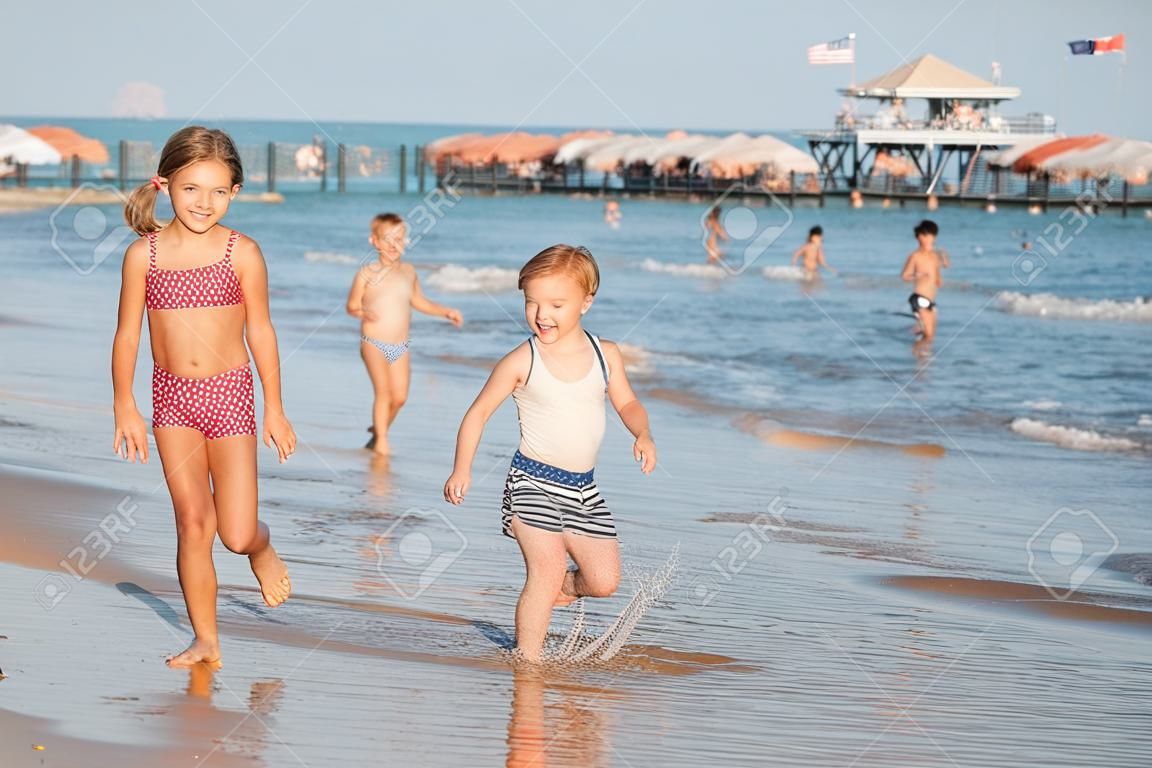 Happy kids on the beach having fun. Summer holiday concept