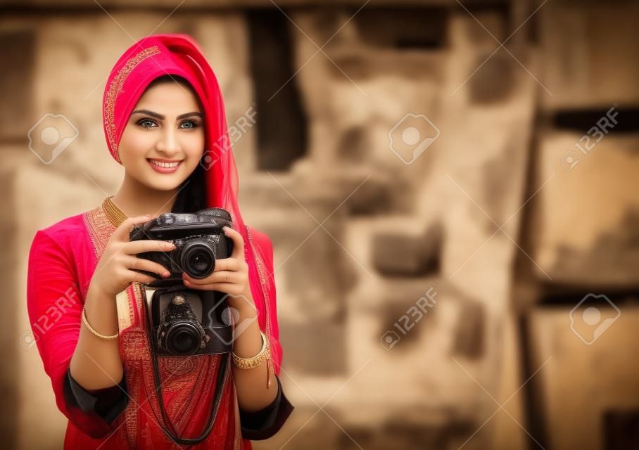 Pretty woman is a proffessional photographer with camera