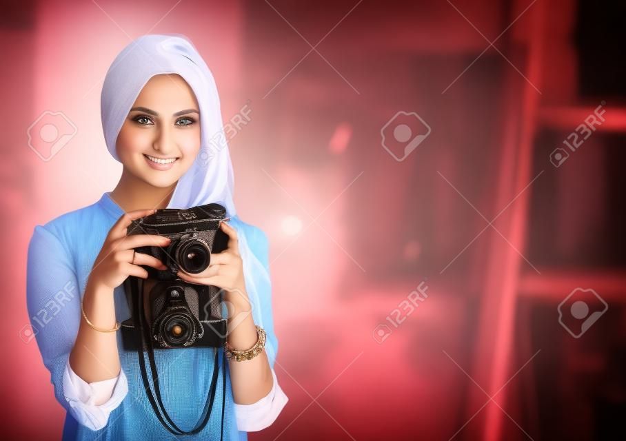 Pretty woman is a proffessional photographer with camera
