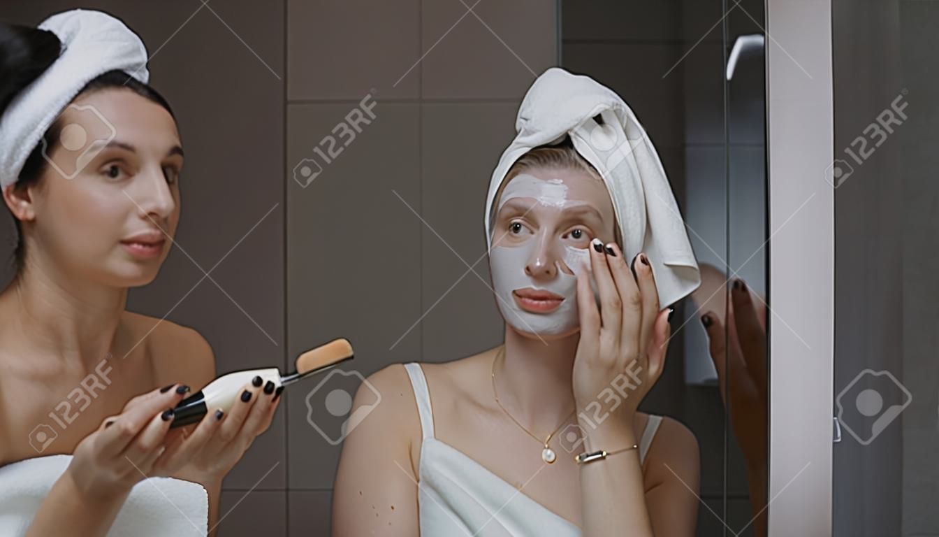 Daily beauty treatment - woman applying clay mask