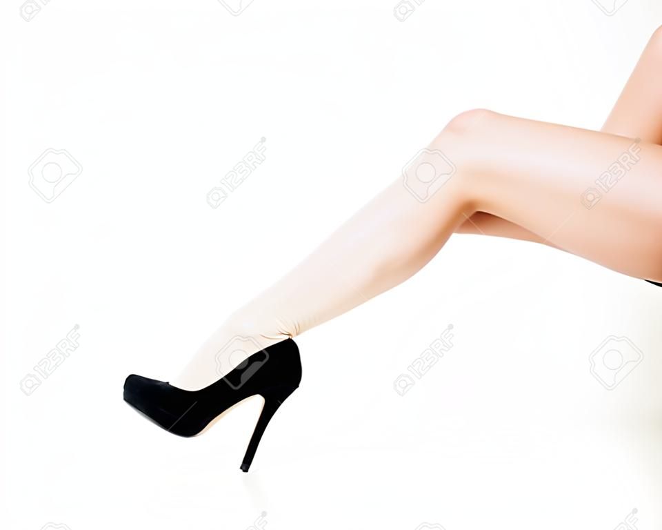 Beautiful female legs in high heels, sitting woman